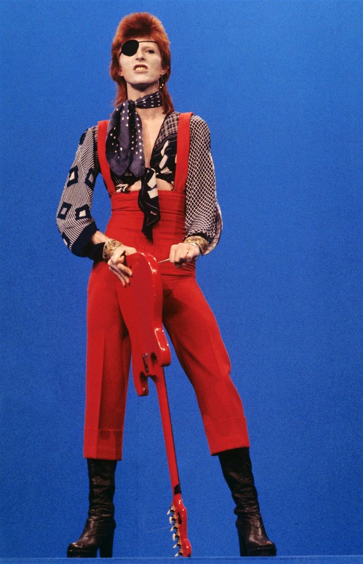 a woman in red pants and black boots