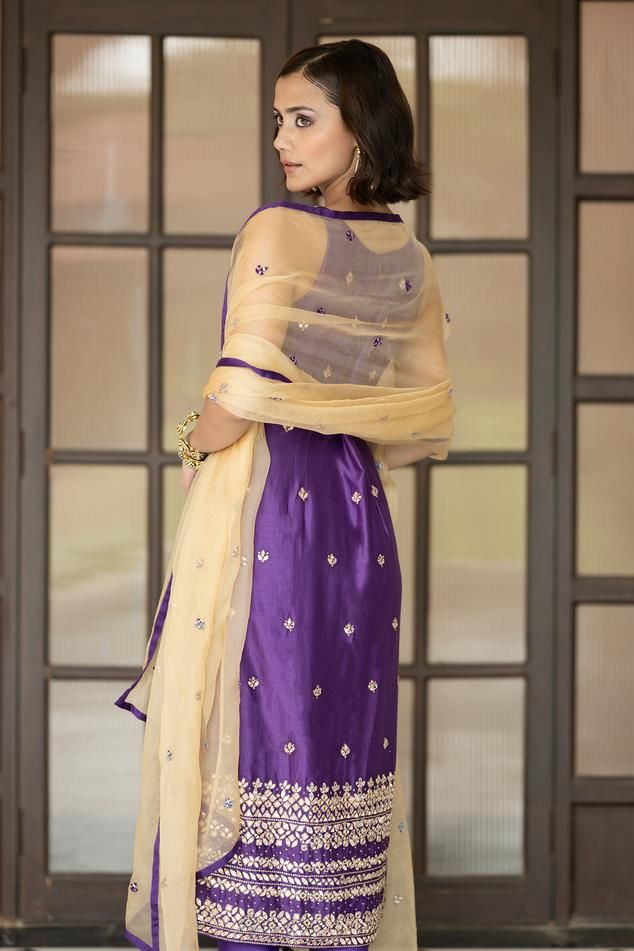 Purple padded kurta with mirror embroidery. Comes with churidar and a dupatta.
Components: 3
Pattern: Embroidered
Type Of Work: Mirror
Neckline: Round
Sleeve Type: Sleeveless
Fabric: Semi crepe, Chanderi, Organza, Lining: Semi crepe
Color: Purple
Other Details: 
Attached lining
Product Weight: 1 Kg
Model Height: 5ft 9inches, wearing size S
Occasion: Mehendi and Haldi - Aza Fashions Mirror Round, Vacuum Storage, Indian Wedding Wear, Embroidered Organza, Straight Kurta, Organza Dupatta, Churidar, Wedding Wear, Set For Women