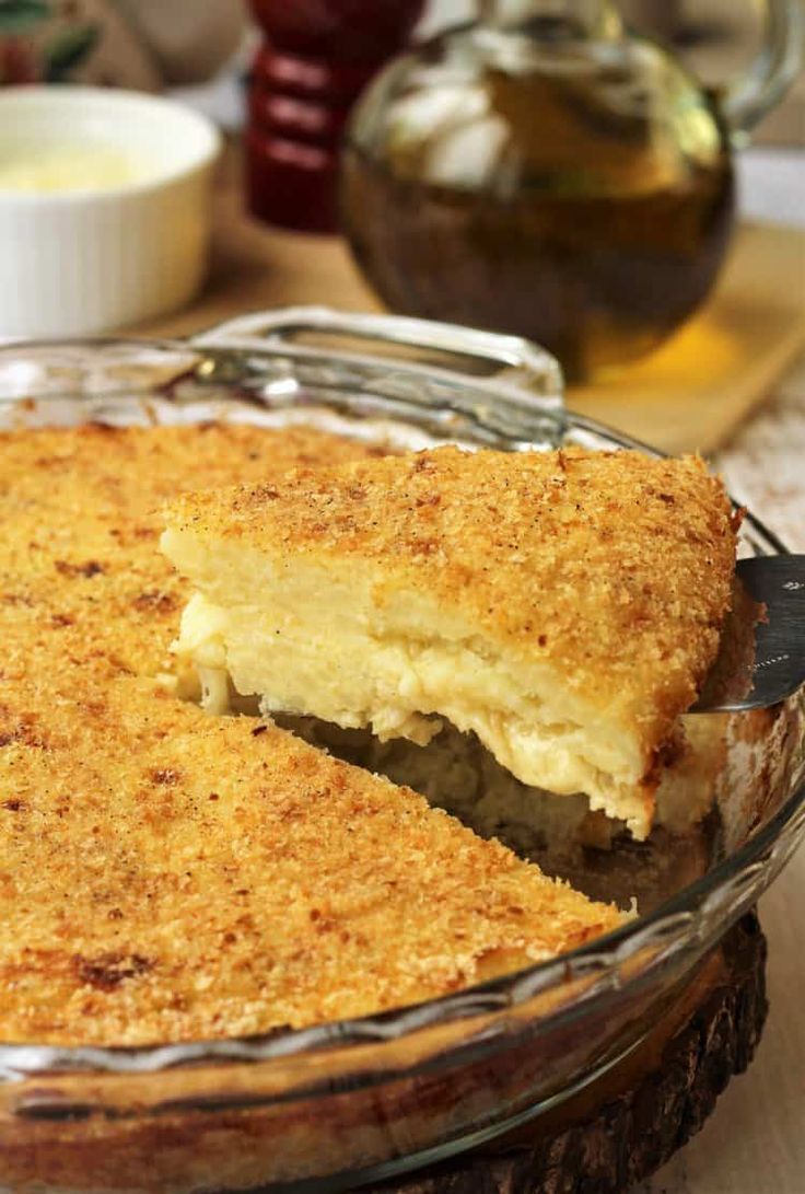 a close up of a pie in a glass dish on a table with other dishes