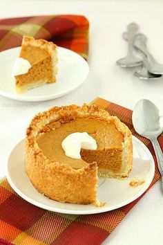 two slices of pumpkin pie on white plates