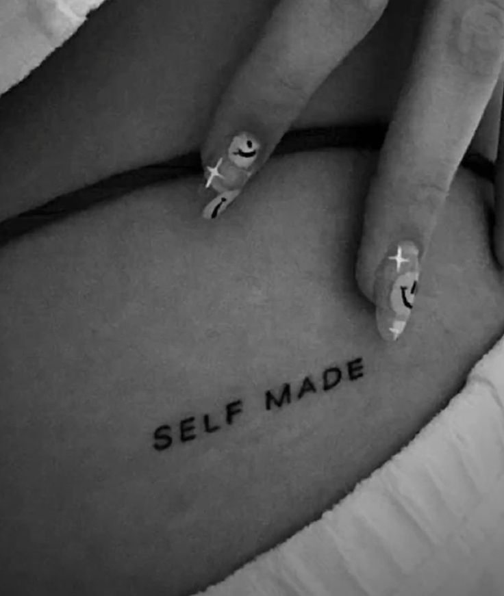 a pregnant woman's belly with the words self made written in black and white