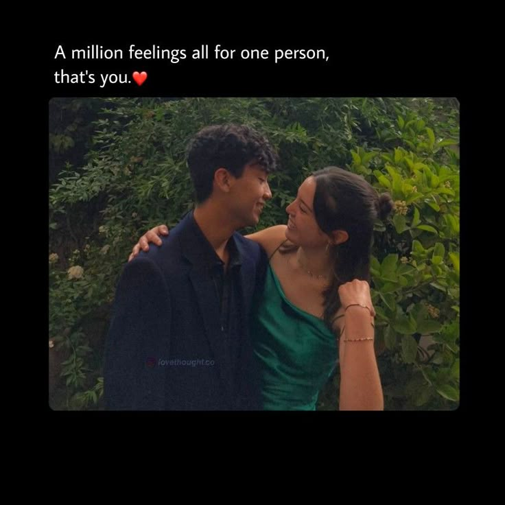 a man and woman standing next to each other in front of some bushes with the caption, a million feelings all for one person, that's you