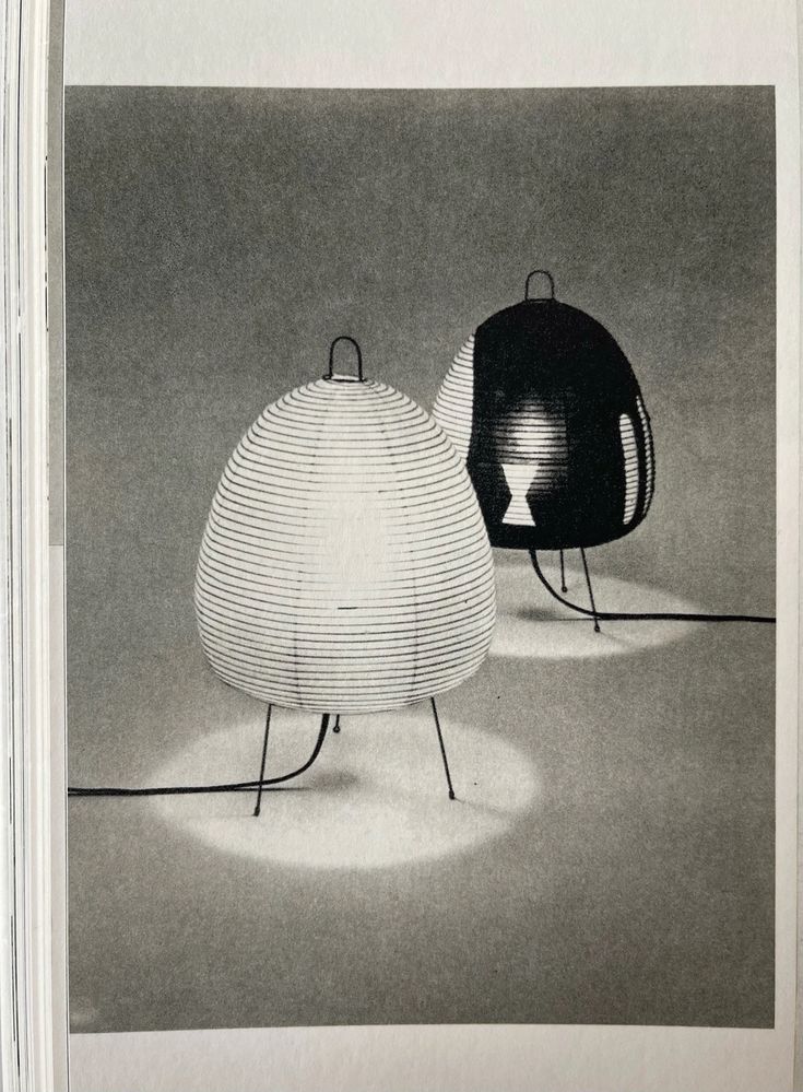 two black and white lamps sitting next to each other