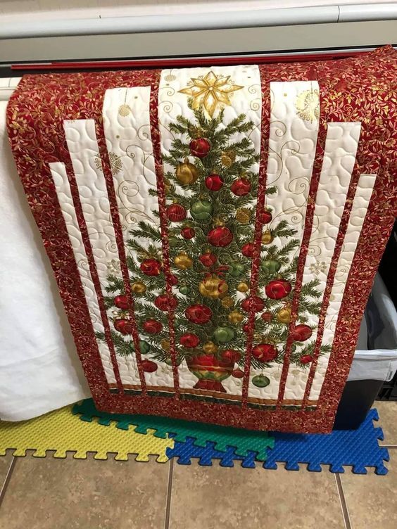 a quilted christmas tree is hanging on the wall