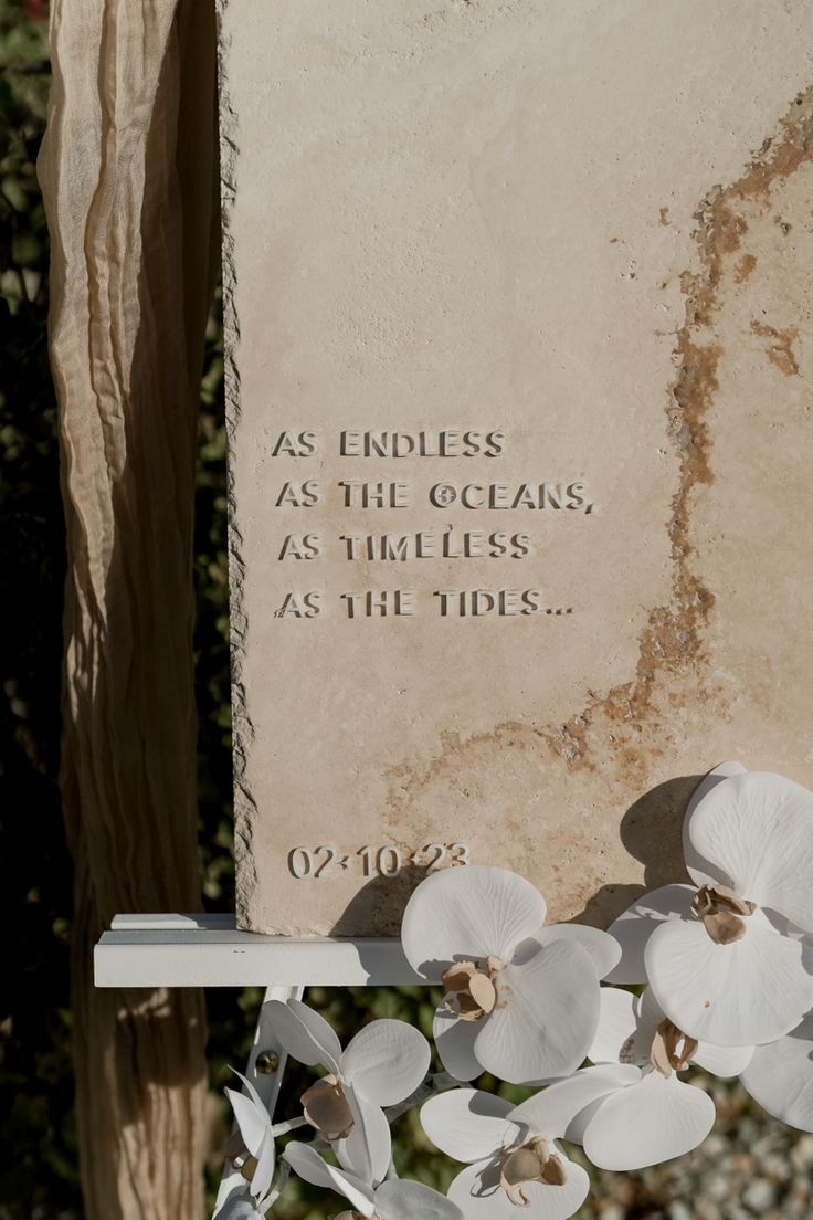 a memorial stone with flowers on it