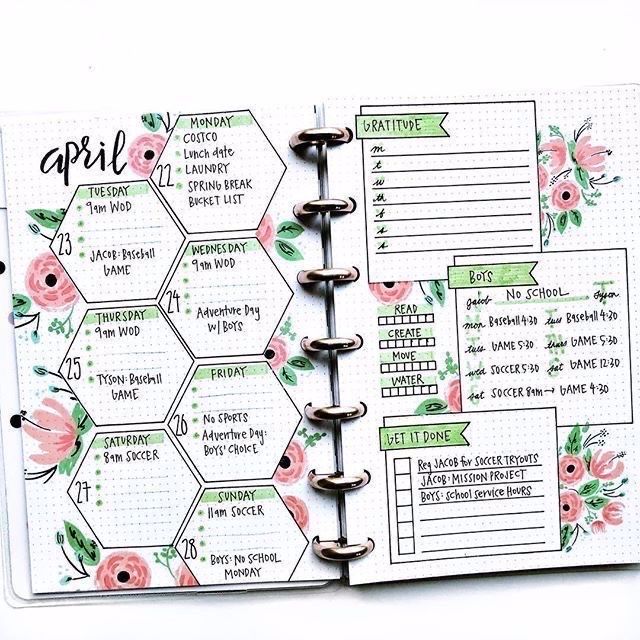 an open planner book with pink flowers on it