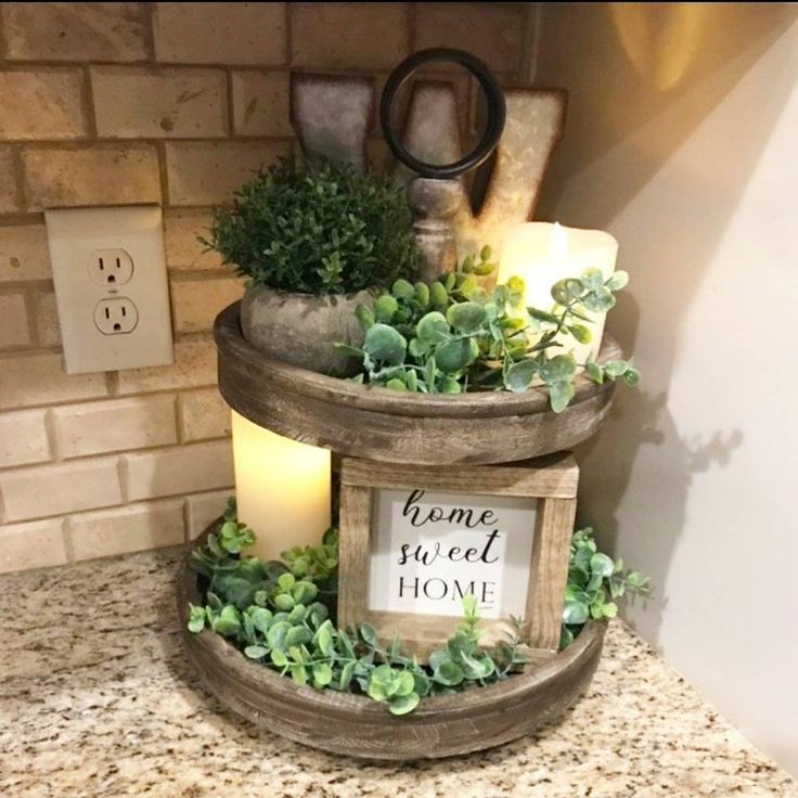 three tiered planter with succulents, candles and a sign that says home sweet home