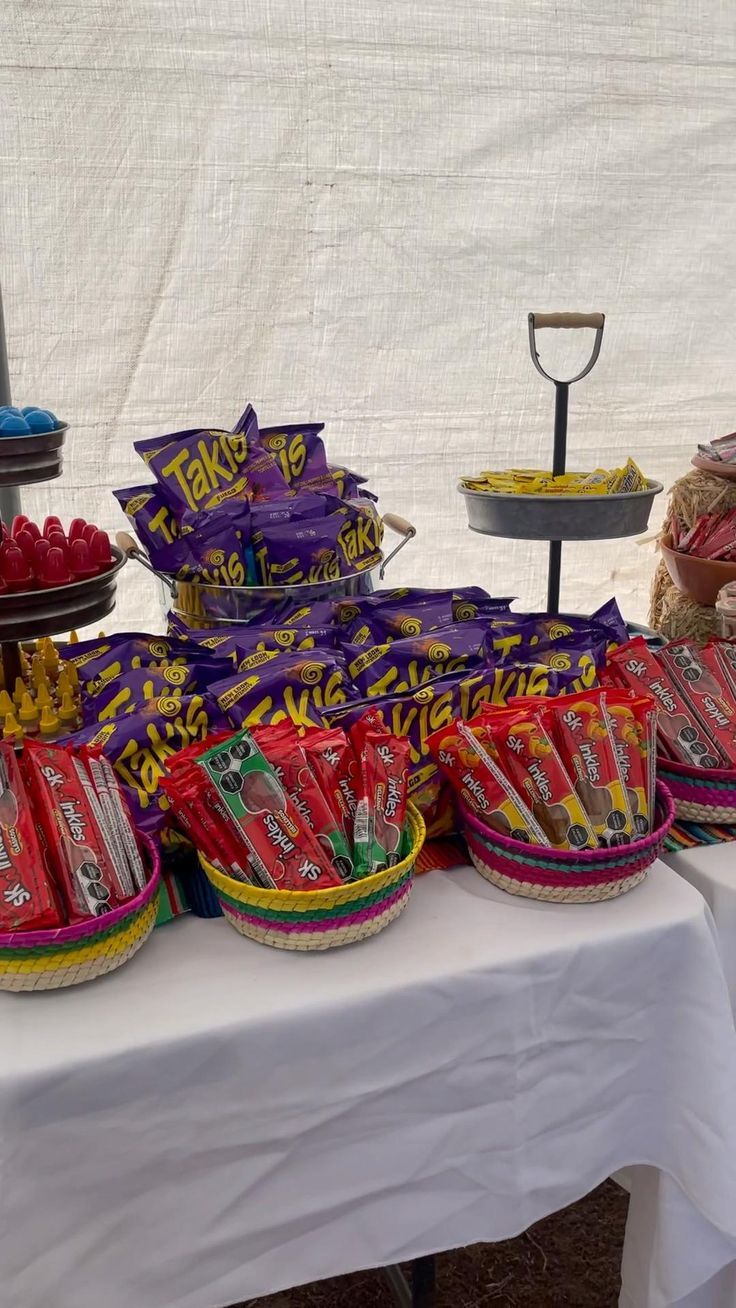 a table topped with baskets filled with candy