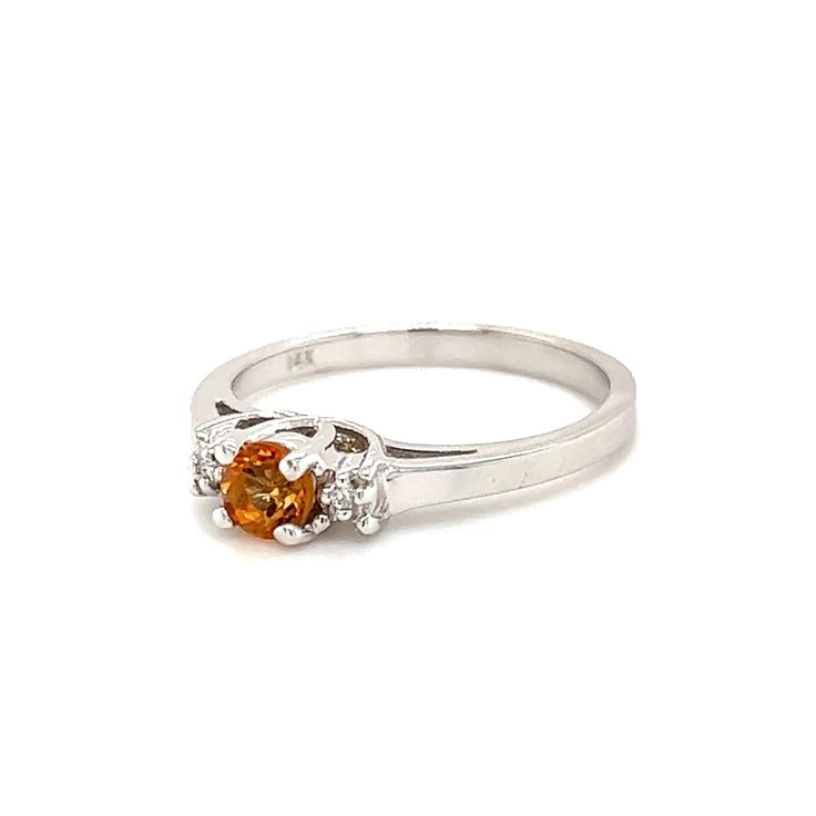 This beautiful 14K white gold ring brings all of the attention to its centerpiece, a 4mm round-cut citrine. The citrine is highlighted by a brilliant round-cut diamond on each side. 14K White Gold Citrine: Round-cut, 4x4mm Diamond: 2 Round-cut Finger Size: 6.75 White Gold Citrine Topaz Ring With Center Stone, White Gold Citrine Birthstone Ring With Gemstone, White Gold Topaz Ring With Citrine, White Gold Citrine Rings With Accent Stones, Orange Topaz Round Ring, Brilliant Round Cut Topaz Birthstone Ring, Round Topaz Ring With Citrine Center Stone, White Gold Diamond Ring With Citrine Accent Stones, White Gold Citrine Diamond Ring With Accent Stones