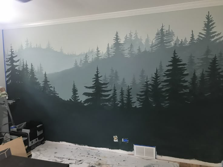 the wall is being painted with black and white trees on it's side,