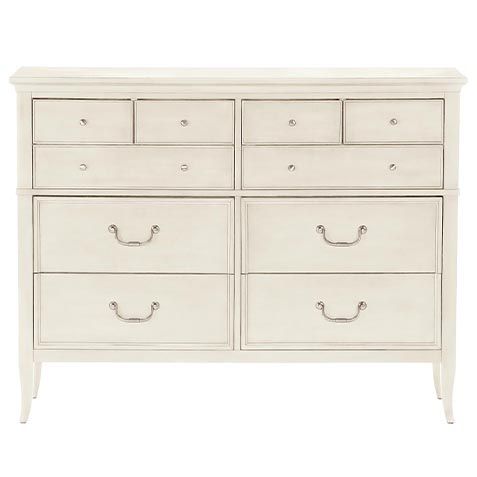 a white dresser with drawers and handles