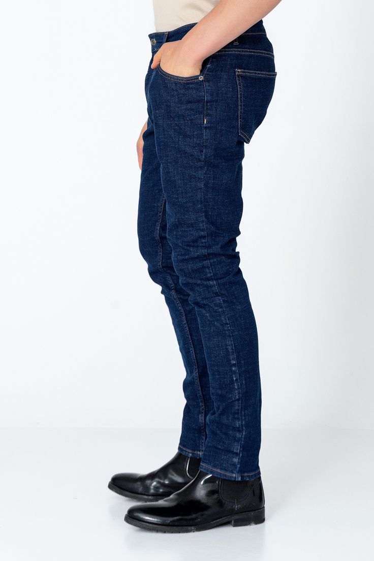 Fitted tapered jeans are a versatile and stylish choice for any wardrobe, offering a flattering silhouette and a modern look. These jeans are crafted from high-quality denim with a hint of stretch, ensuring both comfort and durability. The fitted style hugs the body in all the right places, accentuating curves while providing a sleek and streamlined appearance. The tapered leg adds a contemporary touch, narrowing towards the ankle for a flattering fit that pairs well with both sneakers and boots Modern Dark Wash Denim Jeans, Fitted Indigo Straight Leg Jeans, Fitted Straight Leg Indigo Jeans, Modern Blue Straight Leg Jeans, Modern Denim Blue Jeans With Standard Cut, Modern Denim Blue Jeans For Work, Indigo Mid-rise Jeans With Five Pockets, Modern Blue Jeans With Straight Hem, Modern Blue Bottoms For Everyday