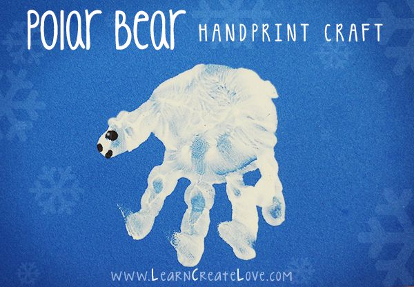 a polar bear handprint craft on a blue background