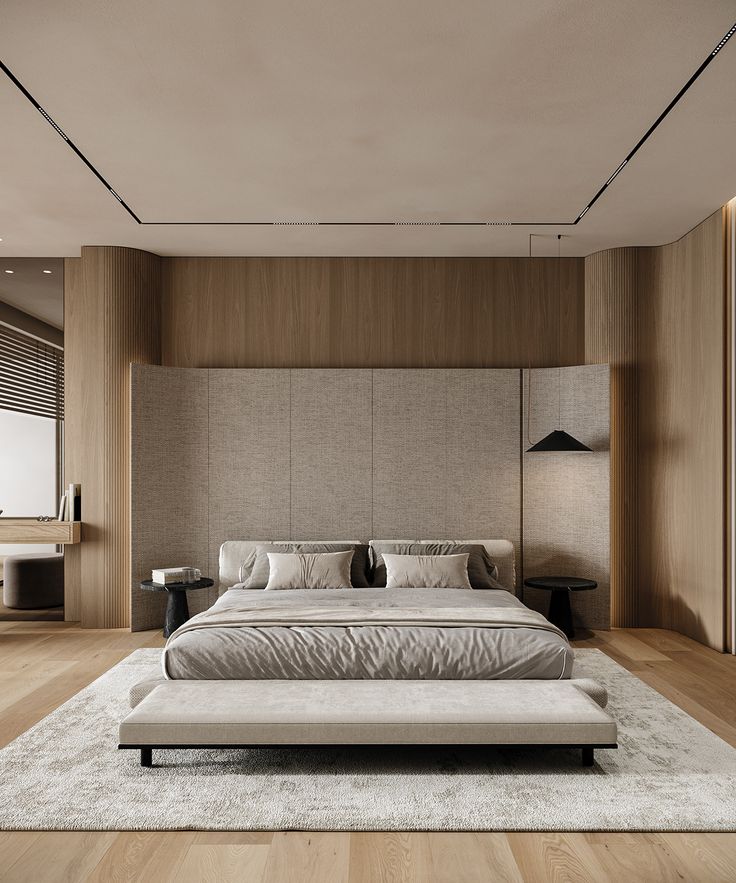 a large bed sitting on top of a wooden floor next to a wall mounted tv