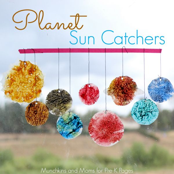 the words planet sun catchers hanging from strings