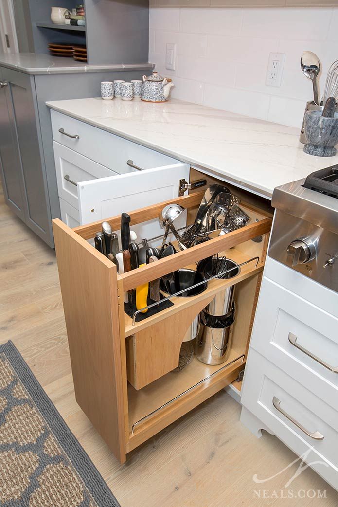 an open drawer in the middle of a kitchen