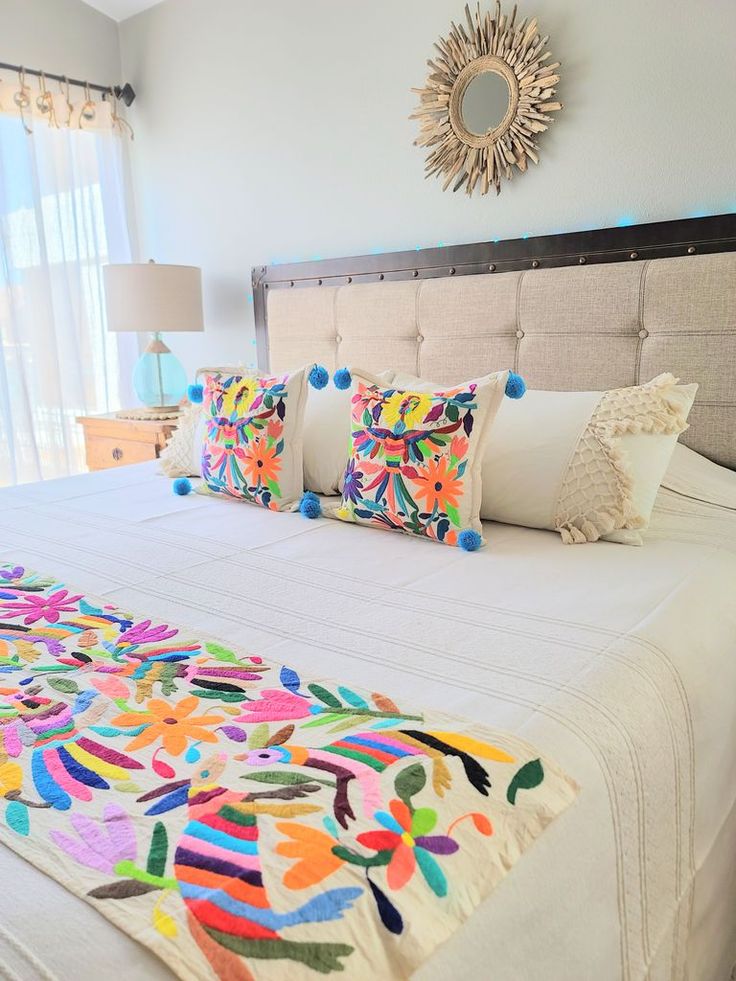 a bed with colorful pillows on top of it