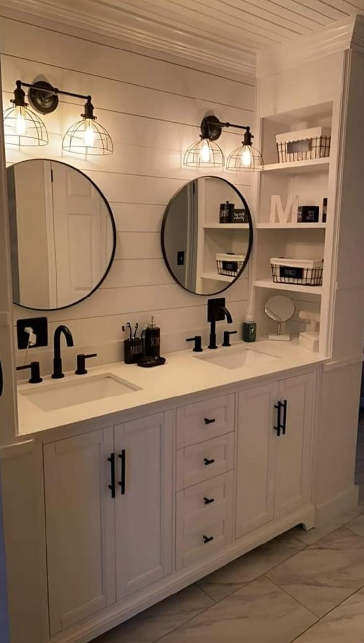 a bathroom with double sinks and two mirrors on the wall next to eachother