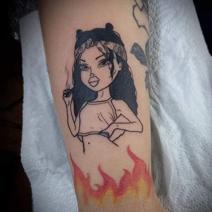 a woman's arm with a tattoo on it that has flames coming out of it