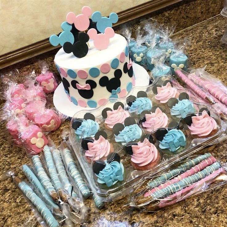 a table topped with lots of cupcakes and cake decorating items on top of a counter