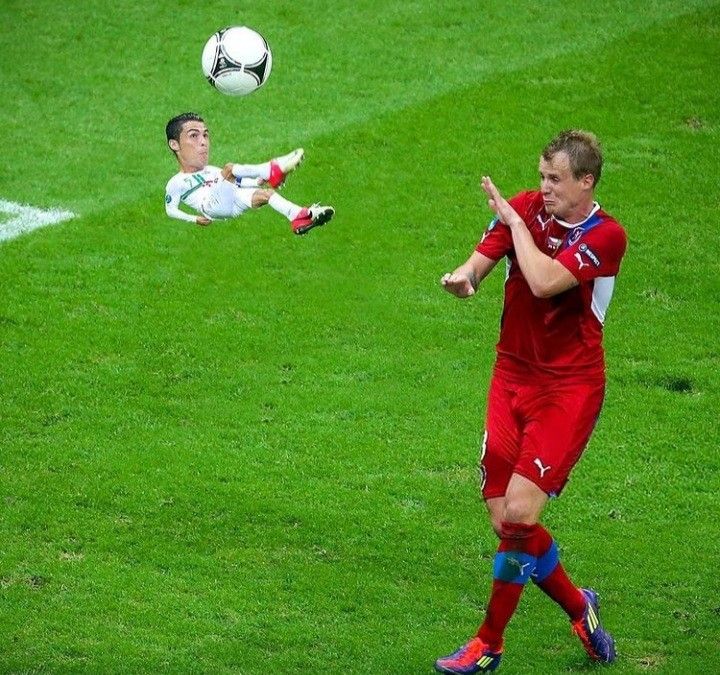 two soccer players are playing on the field