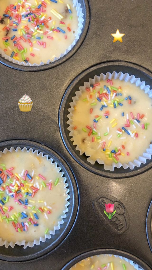 cupcakes with sprinkles are sitting in the muffin tins