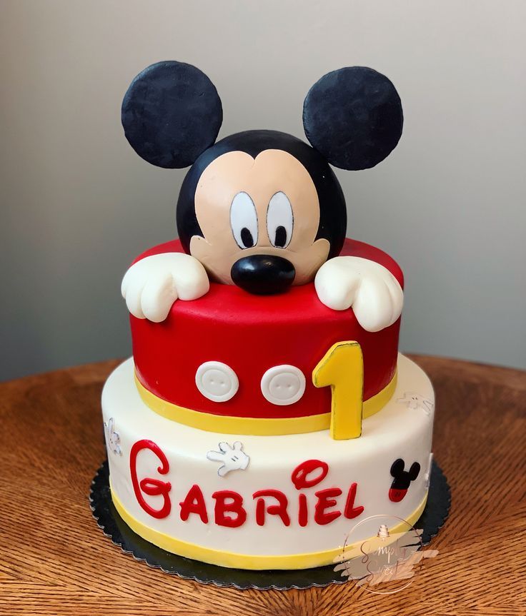 a mickey mouse birthday cake with the number one on it's face and ears