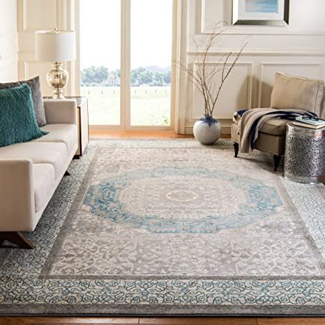 a living room filled with furniture and a large rug