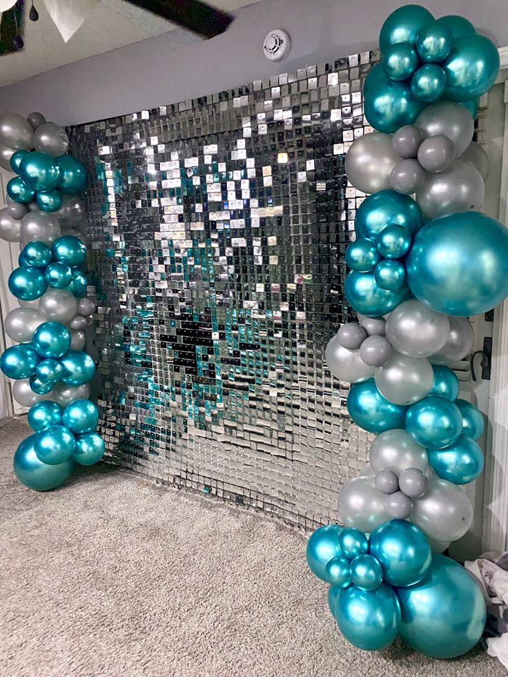 blue and silver balloons in front of a mirror