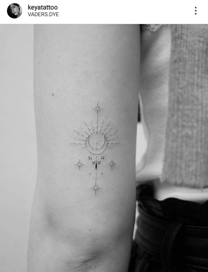 a small sun and stars tattoo on the left side of the right arm is shown in black and white