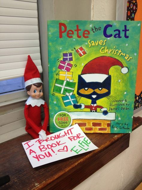 an elf is sitting next to a book about pete the cat