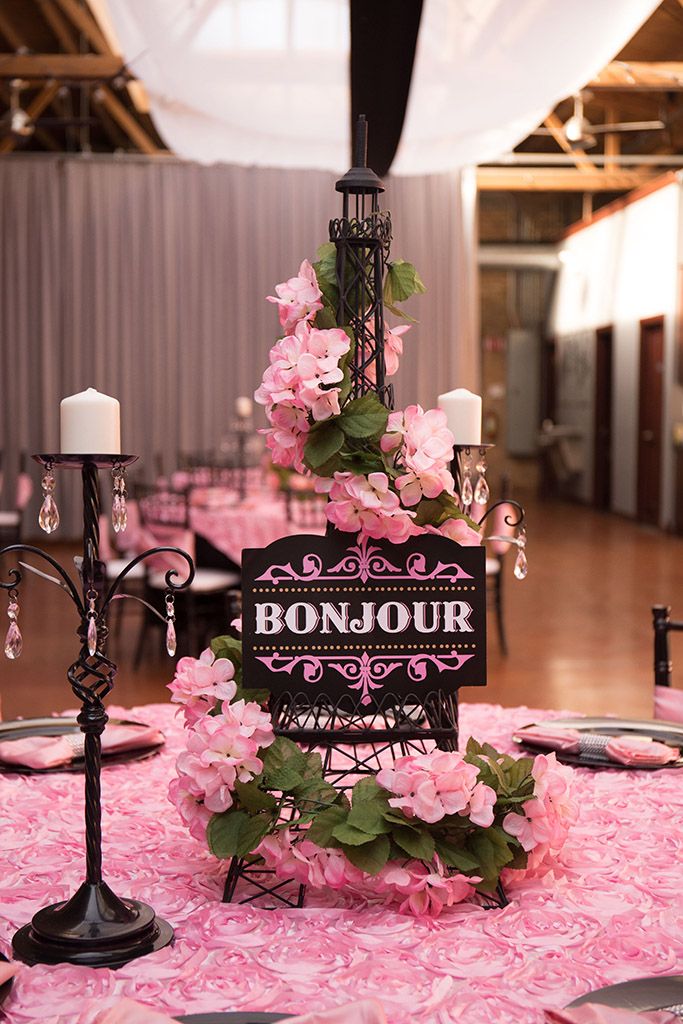 the table is set with pink flowers and candles for an elegant wedding reception at bonjou