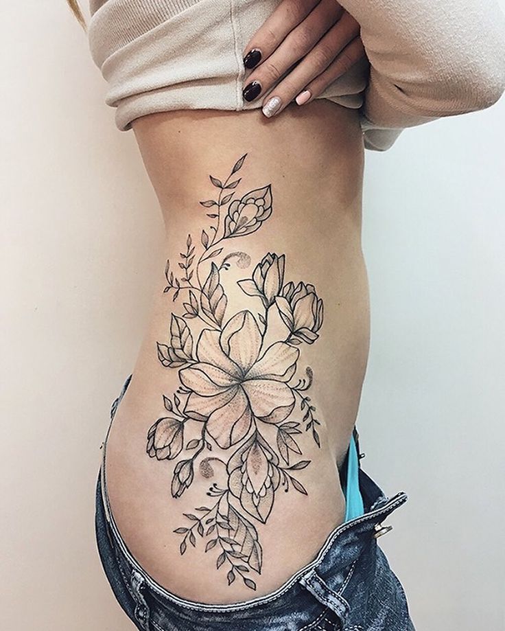 a woman with a flower tattoo on her stomach