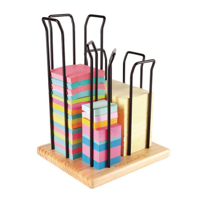 a stack of colorful sticky notes sitting on top of a wooden holder with black handles