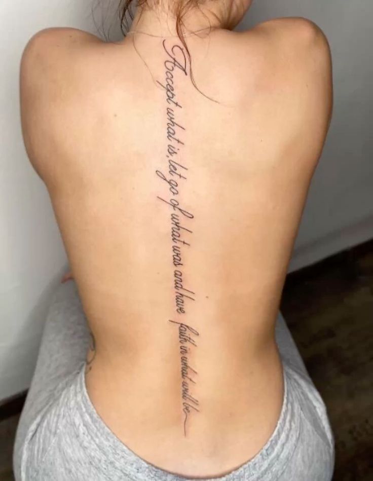 the back of a woman's neck with writing on it