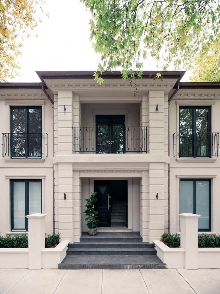 a large white house with black doors and windows