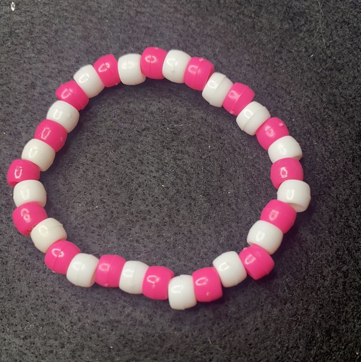 Material: Clear string Color: Pink and blue beads Type: Bracelet Style: Casual Pink Crystal Bracelet With Letter Beads, Pink Crystal Bracelet With Letter Beads And Round Beads, Adjustable Pink Pearl Bracelet With Spacer Beads, Pink Stretch Bracelet With Spacer Beads As Gift, Adjustable Pink Friendship Bracelets With Spacer Beads, Trendy White Bracelet With Large Beads, Pink Adjustable Crystal Bracelet With Round Beads, Pink Pearl Bracelet With Colorful Beads, Trendy Pink Spacer Beads