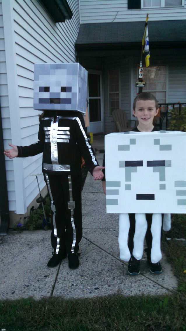 two children dressed up in costumes made to look like minecraft characters, standing on the sidewalk