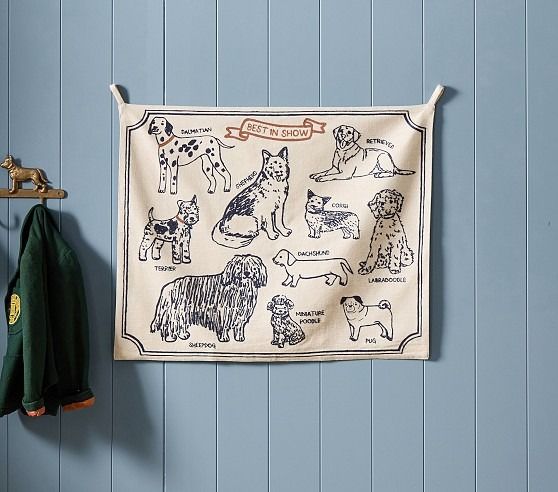 a tea towel hanging on the wall with dogs