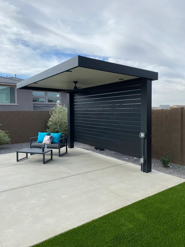 a patio area with a couch and chair