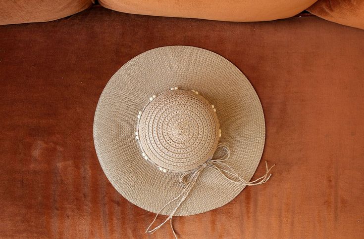 Block the rays in the most stylish of ways! Our BOHEMIAN hat comes in a natural tan woven texture. A straw beaded band tops off the look. Decorate your Summer outfits with a lightweight touch! Measurements: 4” Brim, 3.5” Crown Depth, 7.5” Head Diameter Material: 100% paper Beige Woven Sun Hat For Festival, Adjustable Woven Crochet Hat In Beige, Summer Braided Beige Panama Hat, Beige Woven Straw Hat For Festival, Chic Adjustable Crochet Hat For Beach, Casual Beaded Hats For Spring, Chic Adjustable Crochet Beach Hat, Adjustable Chic Crochet Beach Hat, Chic Natural Crochet Hat For Summer