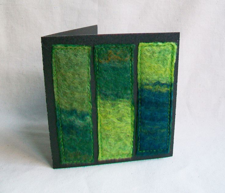 a green and blue book with three sections cut out to look like bookshelves