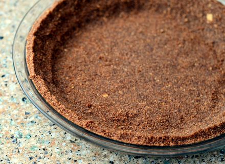 a pie crust in a glass dish on a counter