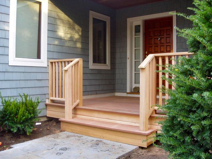 a porch with steps leading to the front door