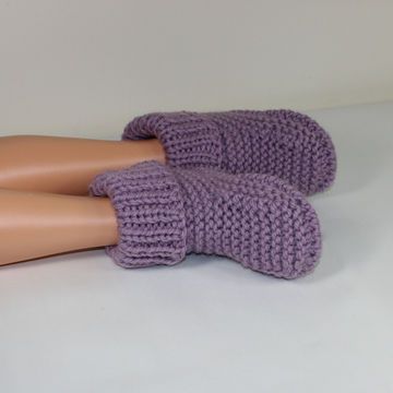 two mannequins wearing purple knitted mittens on top of each other