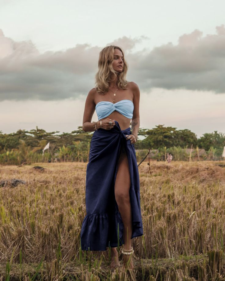 The embodiment of summer, this lightweight slik wrap skirt is printed with the prettiest floral pattern in a rainbow of happy colors. Tie it over a bodysuit, mix it or match it with our too cute Bia bandeau tops and the matching easy Brizo top. Style it wrapped or ruched. There’s no going wrong here. Color: Navy 100% Thai Silk Long, flowing silhouette Graceful understated ruffle Long soft tie for multiple wrap options Ruffle length 12.5” Overall length 43” Dry clean or gently cold water hand was Luxury Resort Wear, Ruffle Maxi Skirt, Bandeau Tops, Thai Silk, Wrap Maxi Skirt, Silk Taffeta, Silk Wrap, Eco Fashion, Happy Colors