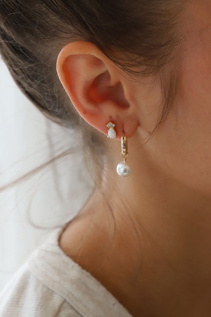 As seen on your favorite influencers, the Audrey Pearl Hoops are a staple in any jewelry collection. These earrings come in two sizes fit for any occasion. Available in small or large gold filled hoop with small and large organic shaped round pearl drop! Details: - Gold filled hoops - Organic pearl - 2x13mm small hoop, 2x18.7mm large hoop - 10mm large pearl, 8mm small pearl SKU: E1260 Materials+Care Black Tie Jewelry, Shea Mcgee, Gold Filled Hoops, Pearl Hoop Earrings, Chain Choker, Pearl Drop Earrings, Pearl Drop, Jewelry Gift Box, Pendant Earrings