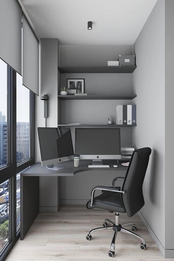 an office with two computer monitors and a desk in front of a window overlooking the city