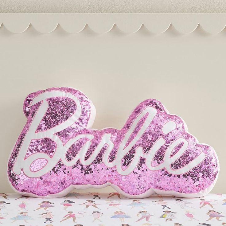 a pink pillow with the word barbie on it