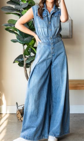 Step into effortless style with the Devin Denim Jumpsuit, featuring a medium-washed denim finish and a chic, sleeveless design. The button-down front and collared neck add a touch of sophistication, while the big cargo chest pocket and back pockets offer practical flair. With a ruched waist back and extra-wide pant legs, this jumpsuit combines comfort and fashion for a versatile, standout look. Measurements (based on flat lay): Small: Chest 17" Waist 14" Hip 21" Length 59" Inseam 31" Medium: Che High Rise Denim Blue Utility Jumpsuit, Medium Wash Button-up Denim Jumpsuit, Light Wash Button-up Denim Jumpsuit, Spring Light Wash Relaxed Fit Denim Jumpsuit, Light Wash Relaxed Fit Denim Jumpsuit For Spring, Relaxed Fit Light Wash Denim Jumpsuit For Spring, High Rise Cotton Denim Jumpsuit With Button Closure, High-rise Cotton Denim Jumpsuit With Button Closure, Summer Wide Leg Medium Wash Denim Jumpsuit